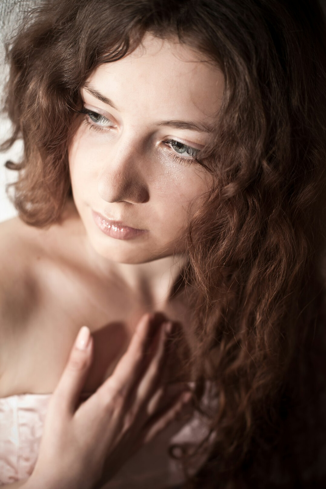 Studio portrait of a young woman with curly hair