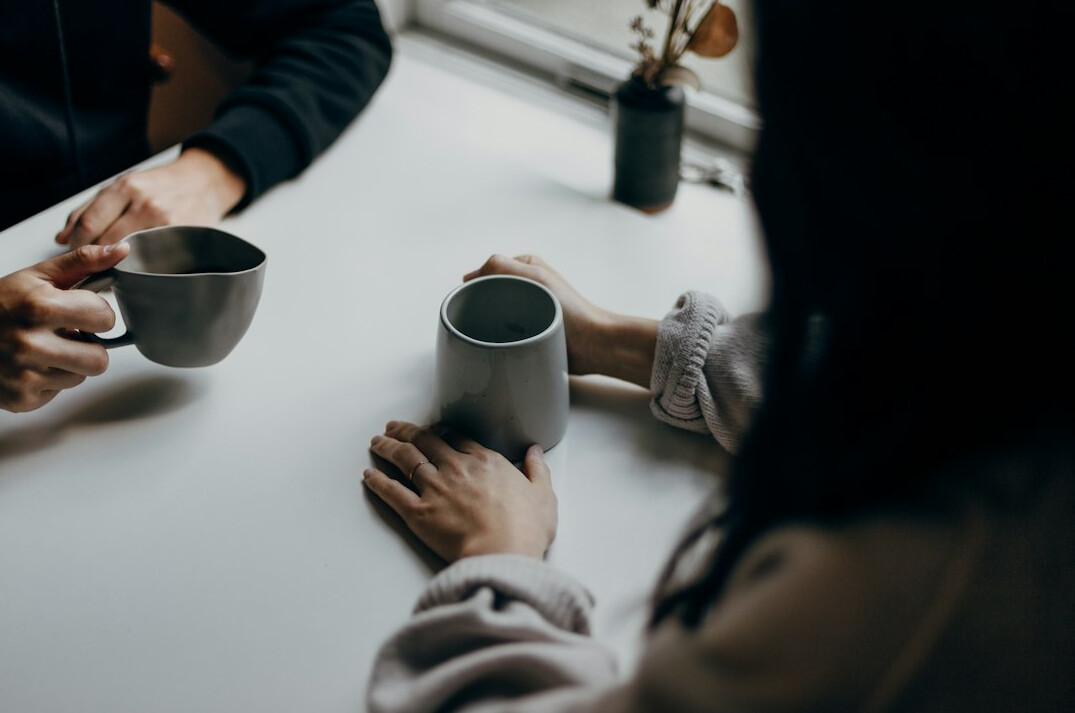 Team meeting around a table in a bright office