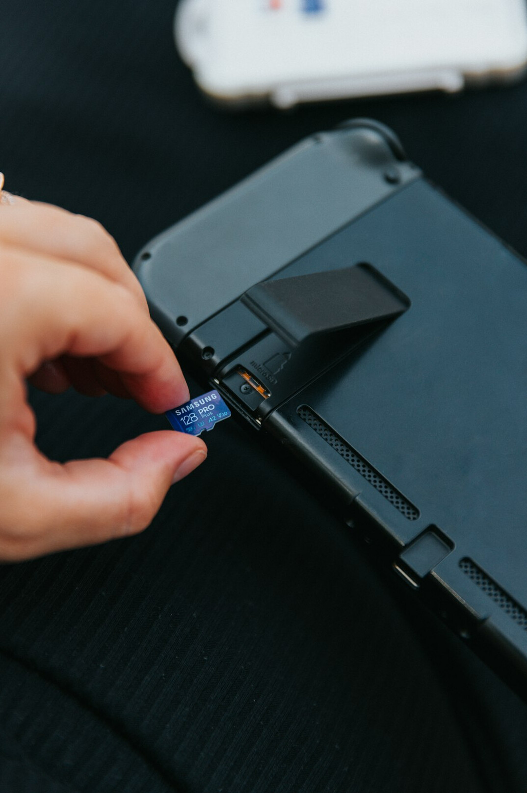 Person pointing at a tablet screen showing a digital document checklist